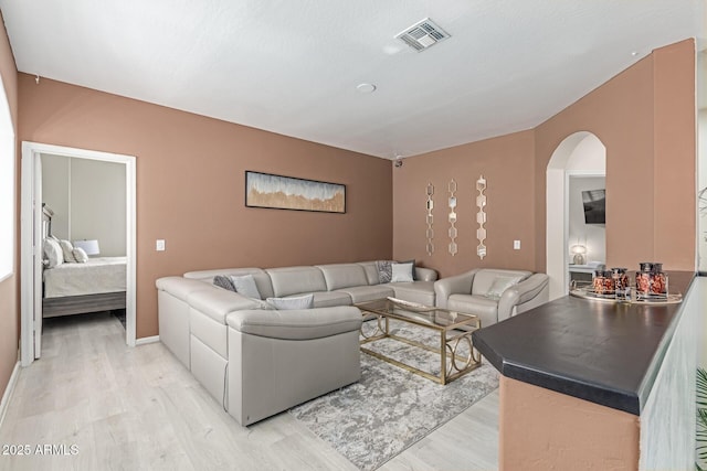 84 E Joseph Way, Gilbert, AZ 85295 - living room featuring light wood-style floors and arched walkways