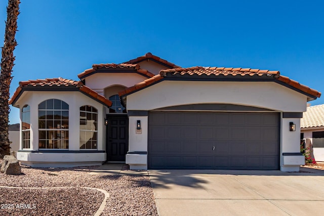 5125 W Wickiup Ln, Glendale, AZ 85308 - mediterranean / spanish house with an attached garage, driveway, a tile roof, and stucco siding