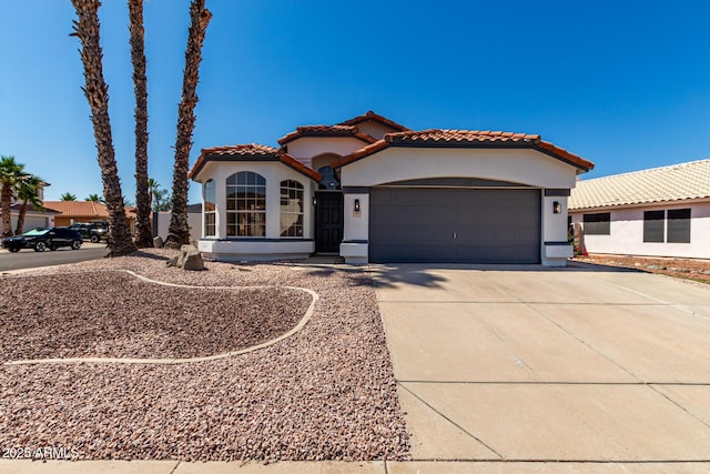 5125 W Wickiup Ln, Glendale, AZ 85308 - mediterranean / spanish-style house featuring stucco siding, a tiled roof, an attached garage, and driveway