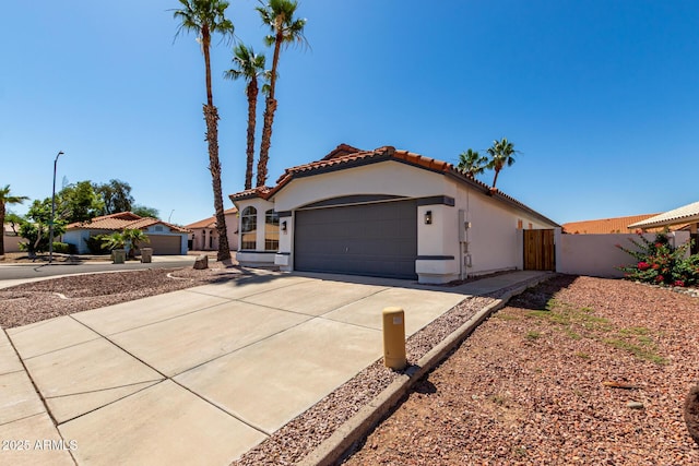 5125 W Wickiup Ln, Glendale, AZ 85308 - mediterranean / spanish home with stucco siding, a garage, a tile roof, and concrete driveway
