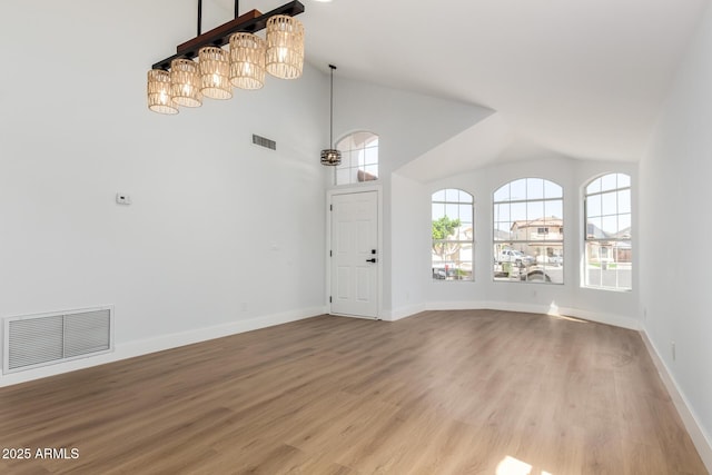 5125 W Wickiup Ln, Glendale, AZ 85308 - unfurnished living room featuring wood finished floors, baseboards, and high vaulted ceiling