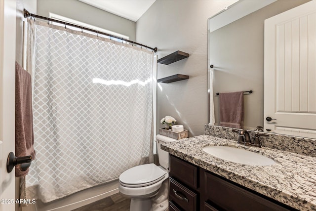 bathroom with wood finished floors, vanity, and toilet