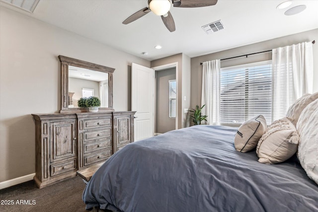 bedroom featuring ceiling fan, baseboards, visible vents, and dark colored carpet