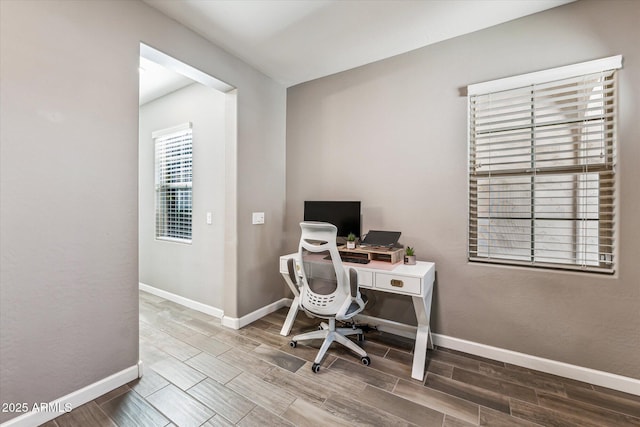 office space with wood finish floors and baseboards