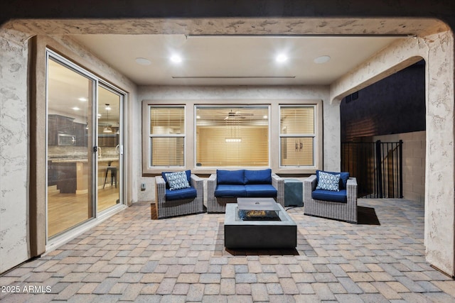 view of patio / terrace with an outdoor living space with a fire pit