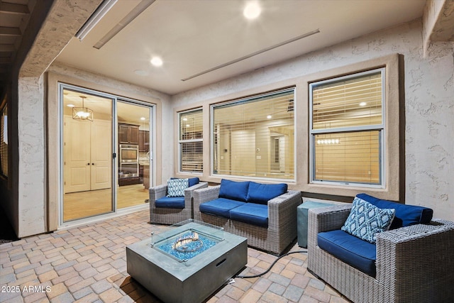 view of patio / terrace featuring an outdoor living space with a fire pit