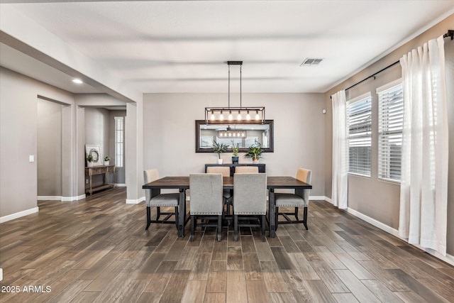 dining area featuring dark wood-type flooring, visible vents, and plenty of natural light