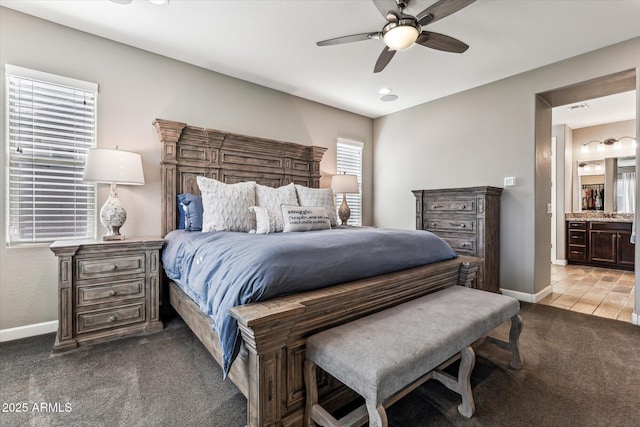 bedroom featuring a ceiling fan, carpet, connected bathroom, and baseboards