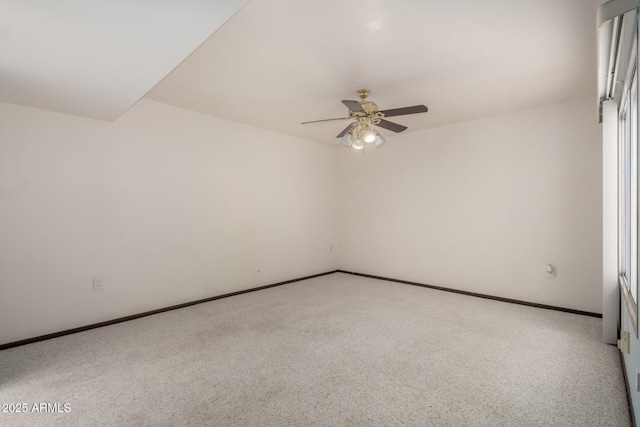 spare room with baseboards, light carpet, and ceiling fan