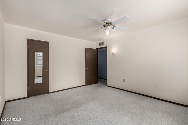 spare room featuring ceiling fan, baseboards, visible vents, and light carpet