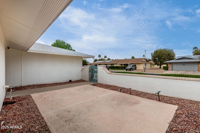 view of patio / terrace with a residential view, fence, and a gate