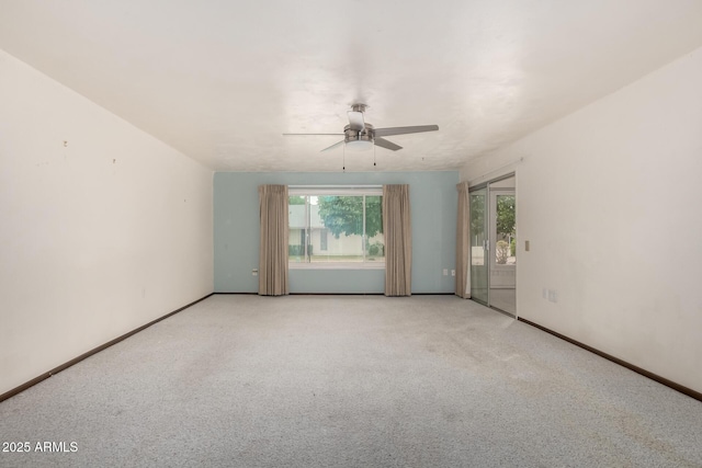 unfurnished room with light carpet, a ceiling fan, and baseboards