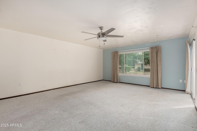 unfurnished room featuring a ceiling fan, light colored carpet, and baseboards