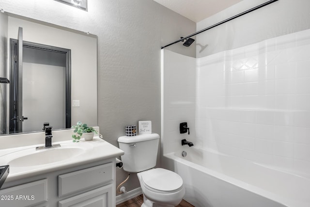 full bathroom with bathing tub / shower combination, a textured wall, toilet, vanity, and wood finished floors