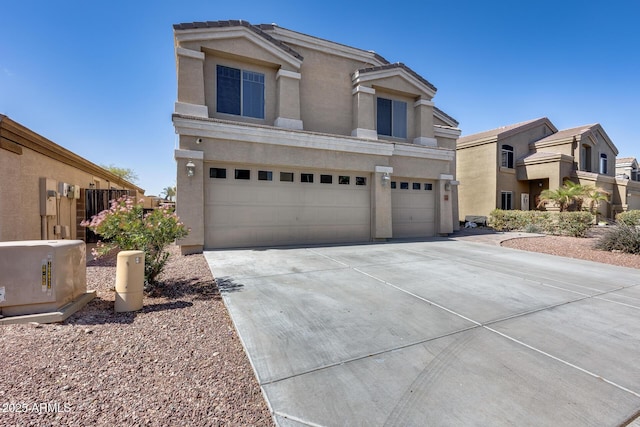 traditional-style house with a garage, concrete driveway, and stucco siding