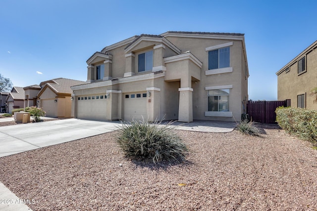 view of front of house featuring concrete driveway, a tiled roof, an attached garage, fence, and stucco siding