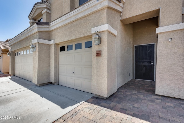 garage featuring concrete driveway