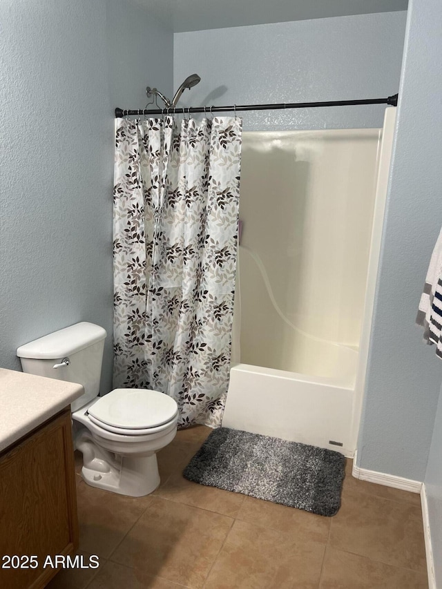 bathroom with tile patterned flooring, toilet, vanity, and shower / bath combo