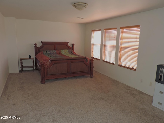 bedroom featuring visible vents and light carpet