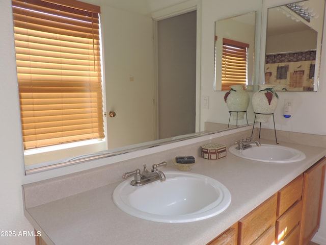 full bathroom with double vanity and a sink