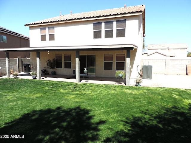 back of property featuring cooling unit, a patio, a yard, and stucco siding