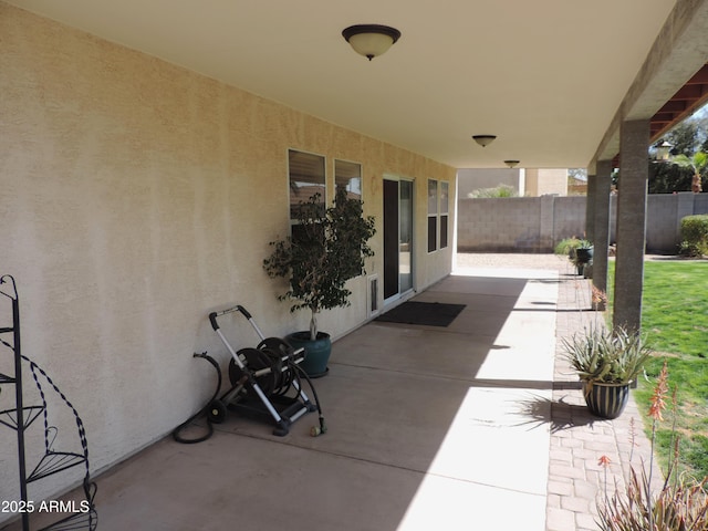 view of patio featuring fence