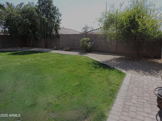 view of yard featuring a patio and a fenced backyard