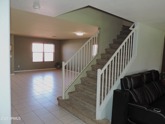 staircase with tile patterned floors and baseboards