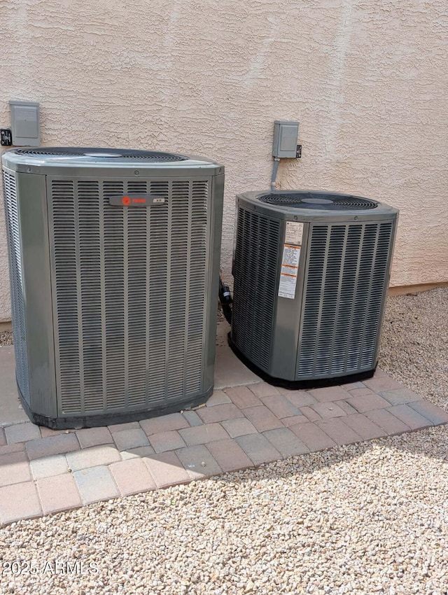 exterior details with cooling unit and stucco siding