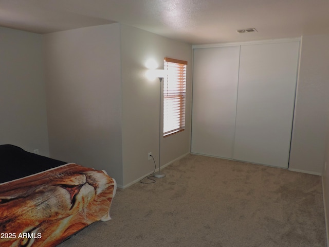 bedroom with light colored carpet and visible vents