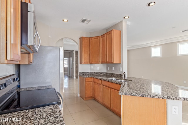 kitchen with sink, dark stone countertops, electric stove, light tile patterned flooring, and ornamental molding