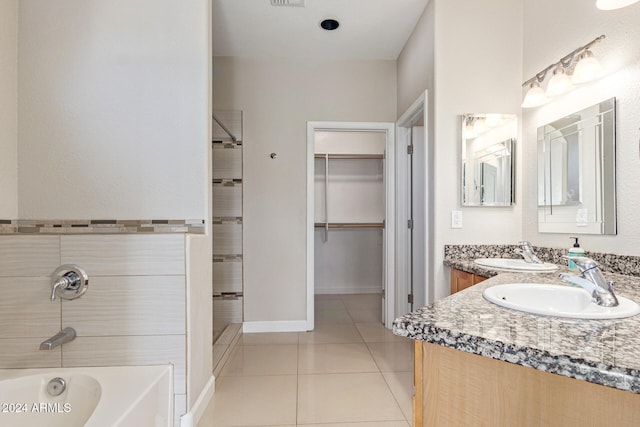 bathroom featuring vanity, tile patterned floors, and tiled shower / bath