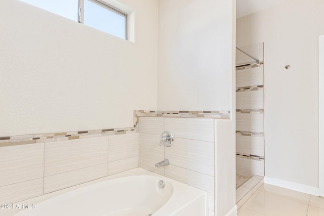 bathroom featuring tile patterned flooring and shower with separate bathtub