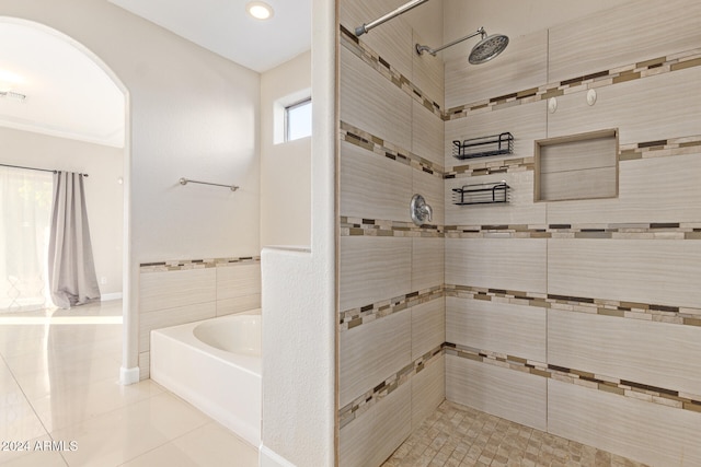 bathroom with tile patterned floors, separate shower and tub, and tile walls