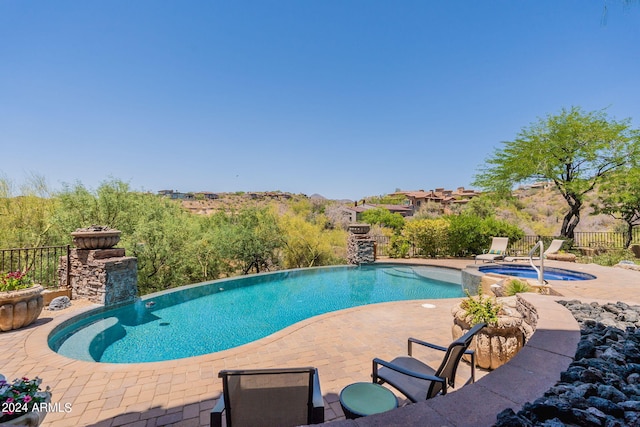 view of pool featuring an in ground hot tub and a patio area