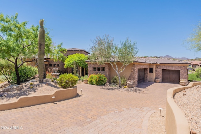 view of front of house with a garage and a mountain view