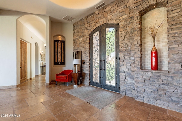 foyer featuring a healthy amount of sunlight and french doors