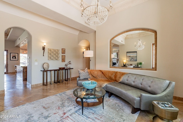 living room with crown molding and a chandelier