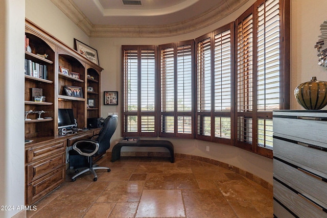 office with a tray ceiling, plenty of natural light, built in desk, and crown molding