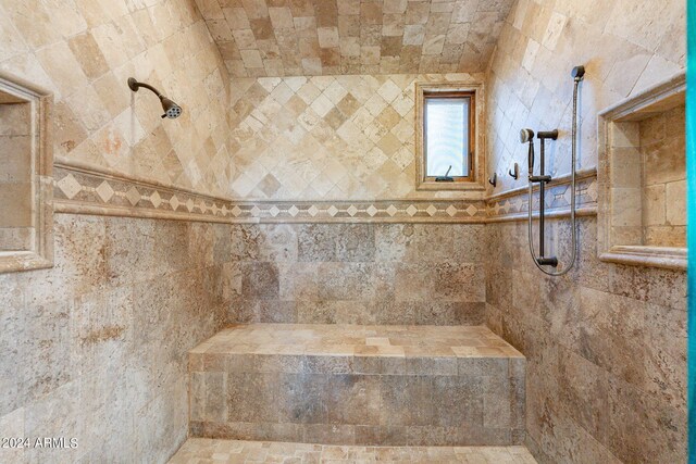 bathroom featuring tile walls and tiled shower