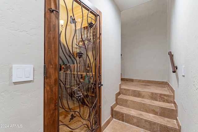 stairs with tile patterned floors