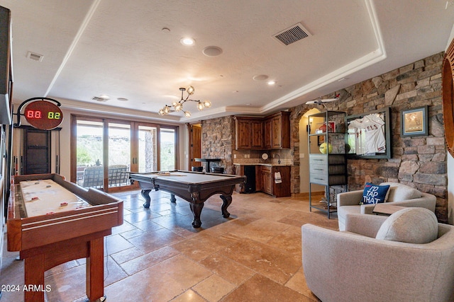 playroom with a fireplace, a tray ceiling, and billiards