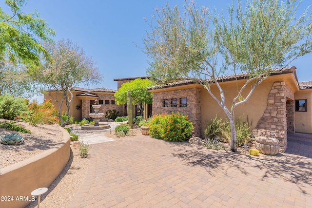 mediterranean / spanish home featuring a patio