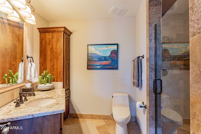 bathroom with vanity, toilet, an enclosed shower, and tile patterned floors