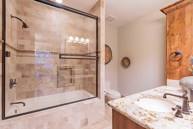 full bathroom featuring toilet, vanity, and combined bath / shower with glass door