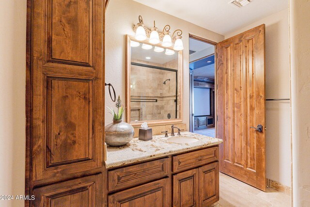 bathroom featuring vanity and a shower with shower door