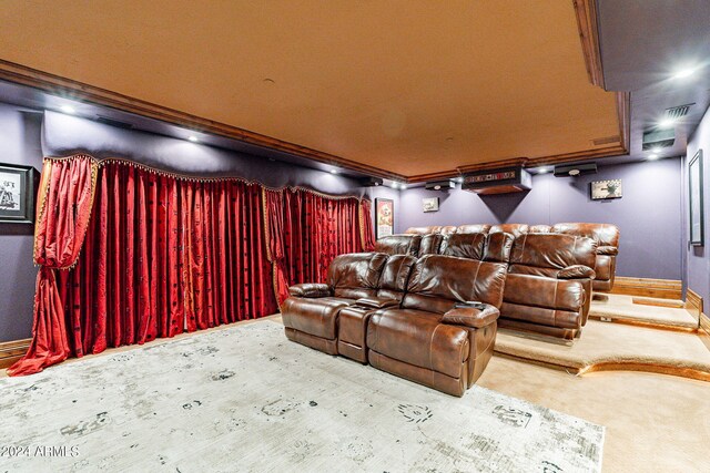 home theater room featuring carpet floors and ornamental molding