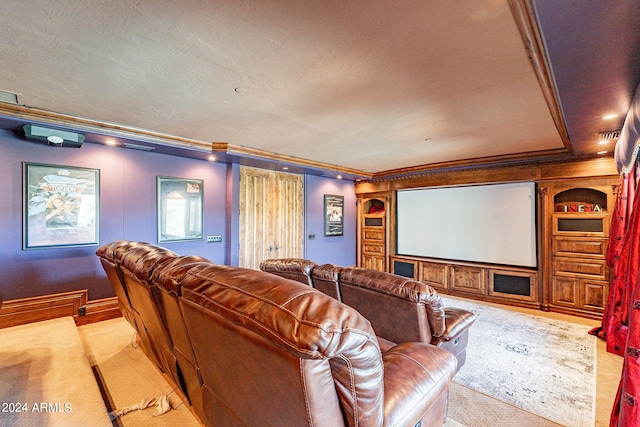 cinema room featuring light carpet, a textured ceiling, and ornamental molding