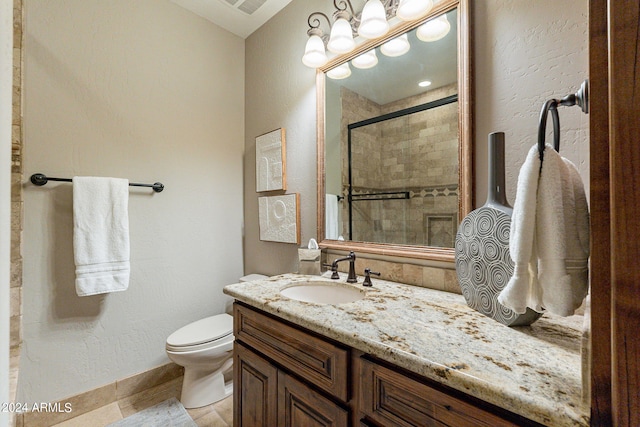 bathroom featuring an enclosed shower, vanity, and toilet