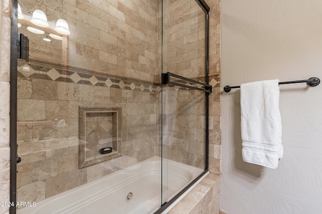 bathroom featuring bath / shower combo with glass door